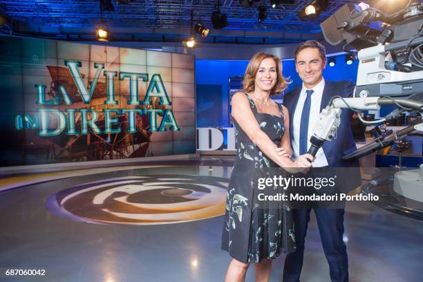 Hosts Liorni Marco and Cristina Parodi next to a TV camera in the studios of the TV program La vita in diretta. Rome, Italy. 4th November 2015