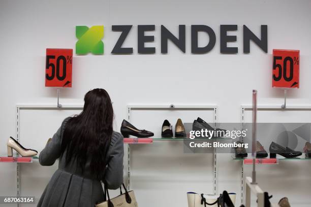 Customers browse footwear inside a Zenden shoe store in Moscow, Russia, on Friday, May 19, 2017. The low-budget shoppers targeted by Zenden are more...