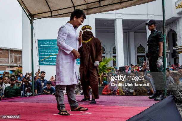 An acehnese man gets caning in public from an executor known as 'algojo' for spending time with a woman who is not his wife, which is against Sharia...