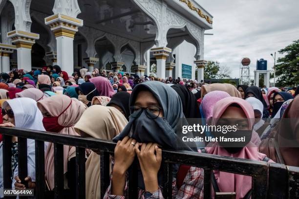 Acehnese people attend public caning for violations against Sharia law at Syuhada mosque on May 23, 2017 in Banda Aceh, Indonesia. The two young gay...