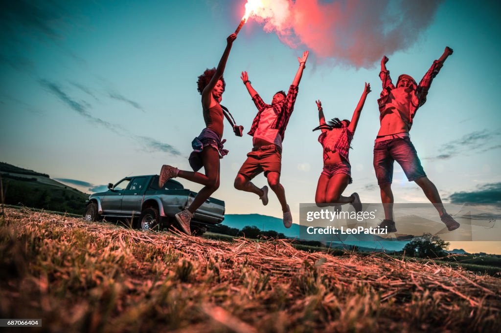 Young friends enjoying the freedom on a Car Trip over a country offroad