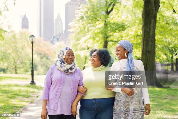 #muslimgirls appreciating their mom - young woman and senior lady in a park stock pictures, royalty-free photos & images