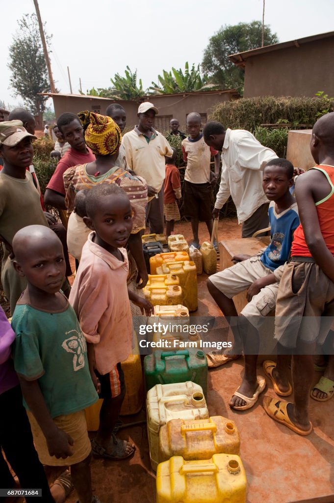 Water Collection Rwanda Children collecting water from well and carrying home. Rwanda. News ...