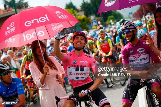 Pink Jersey Tom Dumoulin from Netherlands snaps a selfie next to Cyclamen jersey Colombia's Fernando Gaviria of team Quick-Step before the start of...