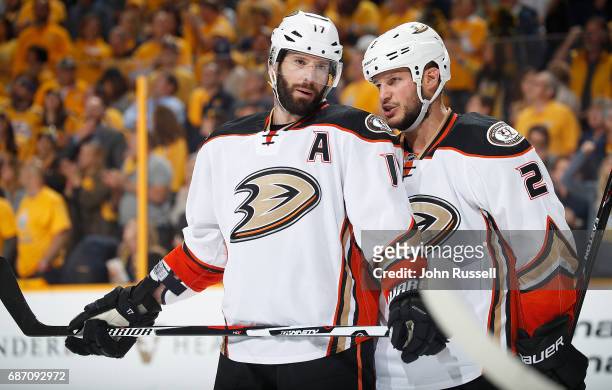 Ryan Kesler talks with Kevin Bieksa of the Anaheim Ducks before a face off against the Nashville Predators in Game Four of the Western Conference...