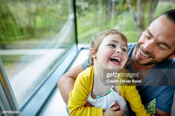 happy father cuddling with little daughter - vida sencilla fotografías e imágenes de stock