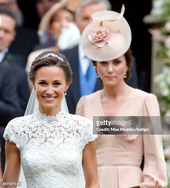 Pippa Middleton leaves St Mark's Church accompanied by Catherine, Duchess of Cambridge after her wedding on May 20, 2017 in Englefield Green, England.