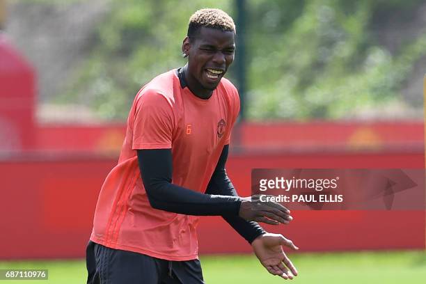 Manchester United's French midfielder Paul Pogba attends a team training session at the club's training complex near Carrington, west of Manchester...