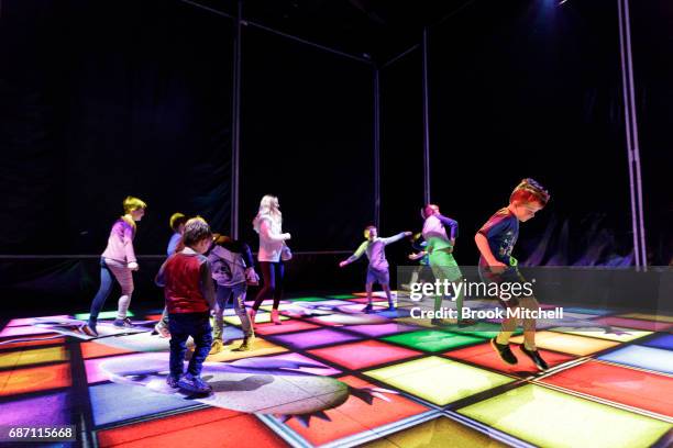 Kids enjoying the Trapdoor installation ahead of the Vivid Festival at Barangaroo Park, Sydney. Trapdoor is described by its creators as an optical...