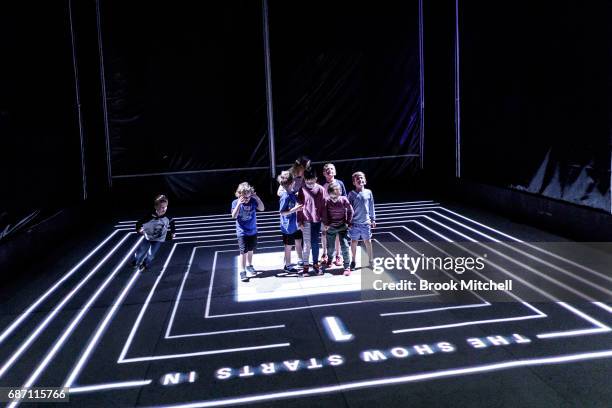 Kids enjoying the Trapdoor installation ahead of the Vivid Festival at Barangaroo Park, Sydney. Trapdoor is described by its creators as an optical...