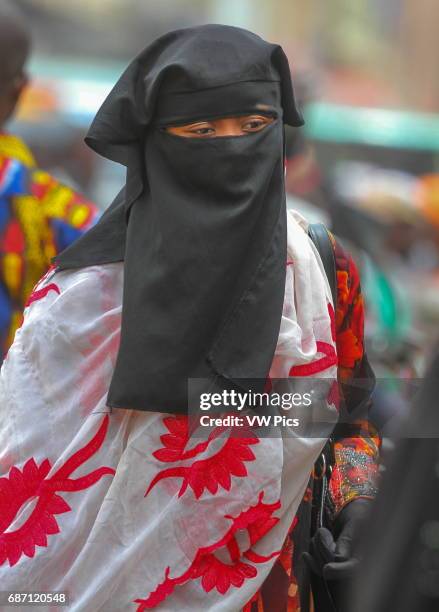 Young lady, muslim outfit, completely covered from head to foot, walking downtown in Bamako the Capital City of Maly/West Africa.