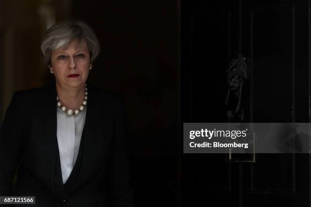 Theresa May, U.K. Prime minister, leaves number 10 Downing Street to deliver a statement in London, U.K., on Tuesday, May 23, 2017. At least 22...