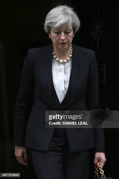 Britain's Prime Minister Theresa May leaves after delivering a statement at 10 Downing Street in central London on May 23, 2017 after an emergency...