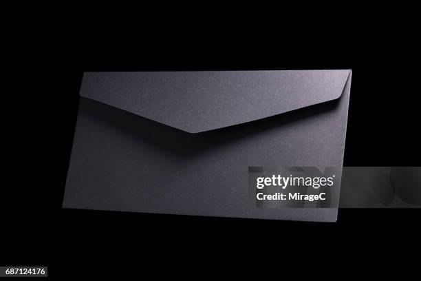 black envelope on black background - kuvert bildbanksfoton och bilder