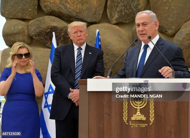 Israel's Prime Minister Benjamin Netanyahu delivers a speech as his wife Sara and US President Donald Trump listen during a ceremony at the Yad...