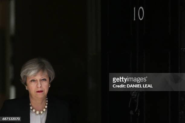 Britain's Prime Minister Theresa May walks to deliver a statement outside 10 Downing Street in central London on May 23, 2017 after an emergency...