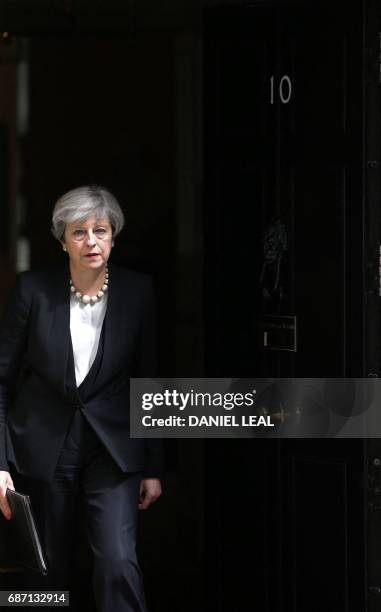 Britain's Prime Minister Theresa May walks to deliver a statement outside 10 Downing Street in central London on May 23, 2017 after an emergency...