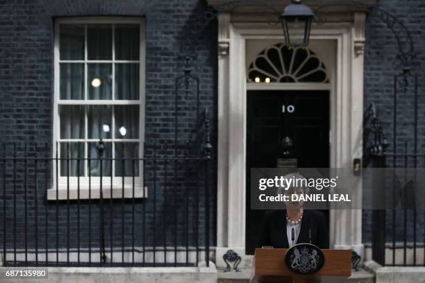 Britain's Prime Minister Theresa May delivers a statement outside 10 Downing Street in central London on May 23, 2017 after an emergency meeting of...