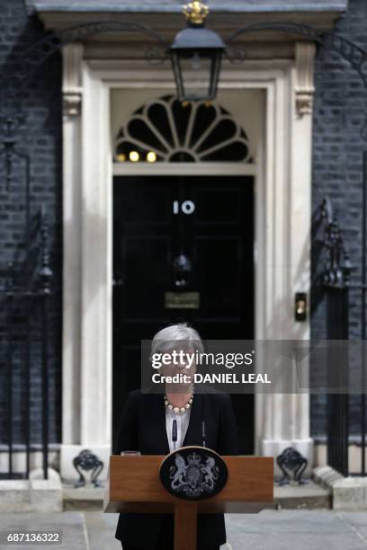 Britain's Prime Minister Theresa May delivers a statement outside 10 Downing Street in central London on May 23, 2017 after an emergency meeting of...