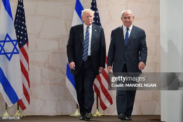 President Donald Trump walks alongside Israel's Prime Minister Benjamin Netanyahu as he arrives to deliver a speech at the Israel Museum in Jerusalem...