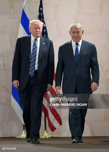 President Donald Trump walks alongside Israel's Prime Minister Benjamin Netanyahu as he arrives to deliver a speech at the Israel Museum in Jerusalem...