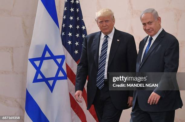 President Donald Trump walks alongside Israel's Prime Minister Benjamin Netanyahu as he arrives to deliver a speech at the Israel Museum in Jerusalem...
