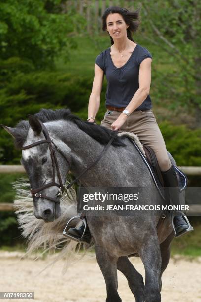 Margot Laffite, daughter of former Formula1 driver Jacques Laffite rides Galaxie at the stable of France's Karim Laghouag, a gold medalist at the Rio...