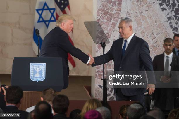 President Donald Trump and Israel's Prime Minister Benjamin Netanyahu shake hands after delivering a speech during a visit to the Israel Museum on...