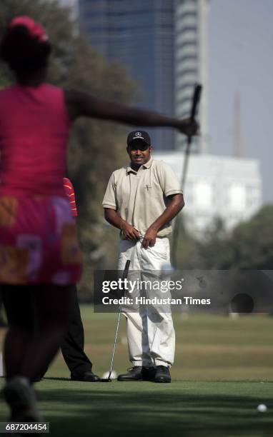 Leander Paes prepares to take a shot at the Wellington Golf Course.