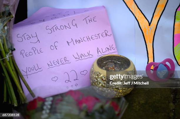 Messages are left amongst tributes left by members of the public in St Ann Square on Tuesday, May 23, 2017 in Manchester,England. At least 22 people...