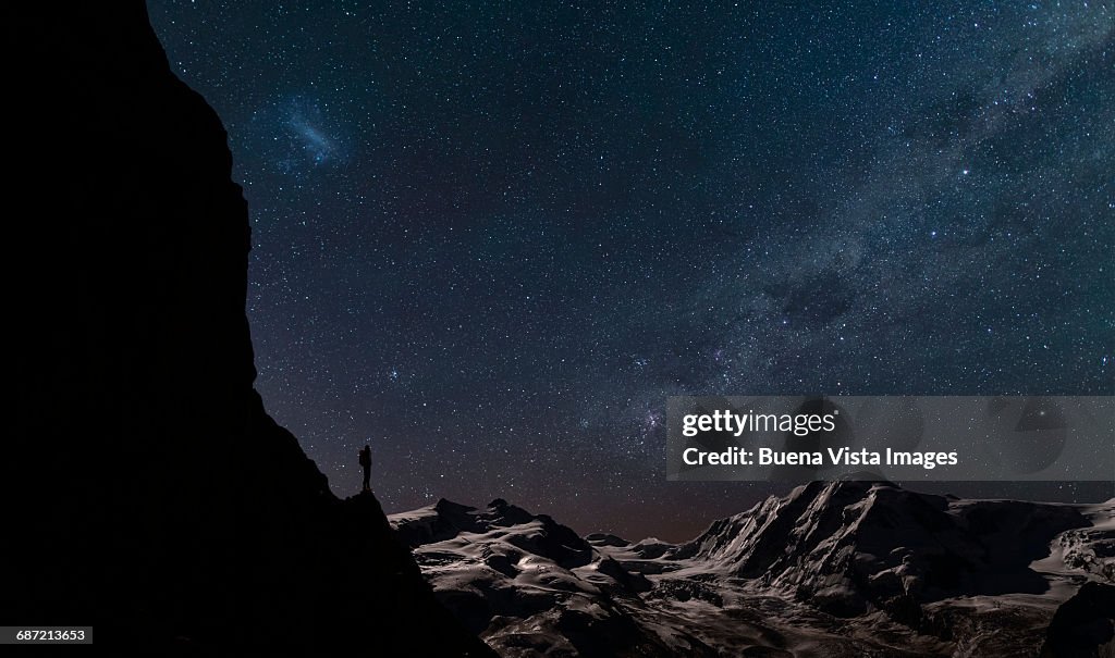 Lone climber watching stars in the sky
