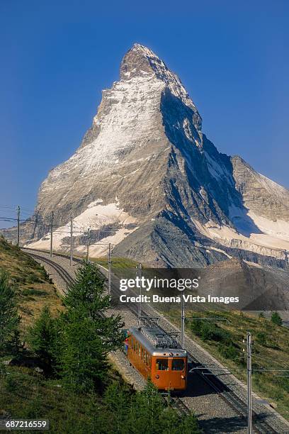 red train under the matterhorn - matterhorn stock pictures, royalty-free photos & images