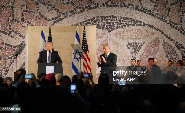 Israel's Prime Minister Benjamin Netanyahu applauds while US President Donald Trump delivers a speech at the Israel Museum in Jerusalem on May 23,...