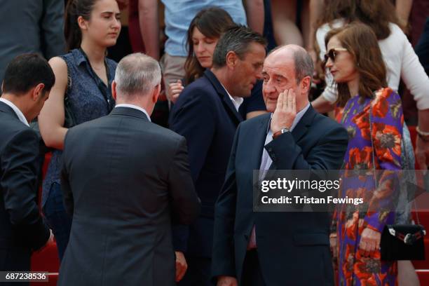 Director of the Cannes Film Festival Thierry Fremaux departs as President of the Cannes Film Festival Pierre Lescure puts his hand to his face after...