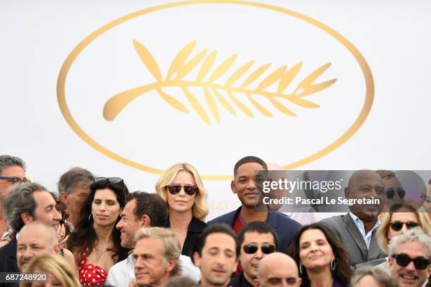 Charlize Theron and Will Smith attend the 70th Anniversary Photocall during the 70th annual Cannes Film Festival at Palais des Festivals on May 23,...