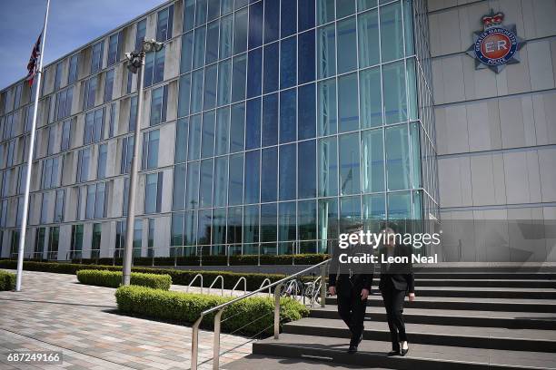 Britain's Prime Minister Theresa May talks with Chief Constable of Greater Manchester Police Ian Hopkins as they leave the Greater Manchester Police...