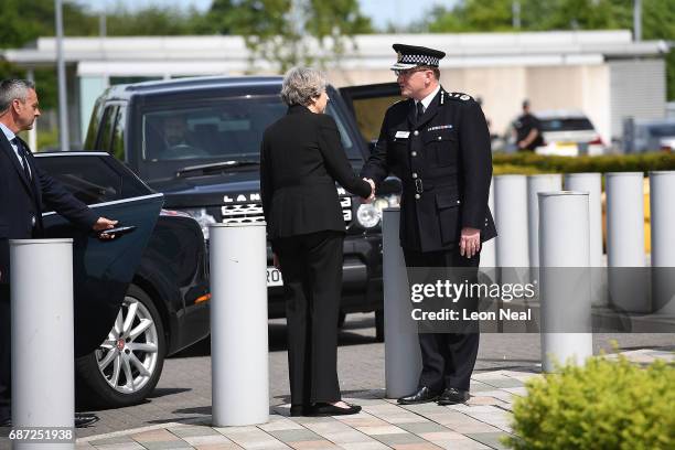 Britain's Prime Minister Theresa May talks with Chief Constable of Greater Manchester Police Ian Hopkins as they leave the Greater Manchester Police...