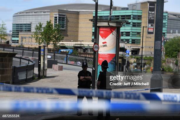 Police stand guard near the Manchester Arena on May 23, 2017 in Manchester, England. At least 22 people were killed in a suicide bombing at an Ariana...