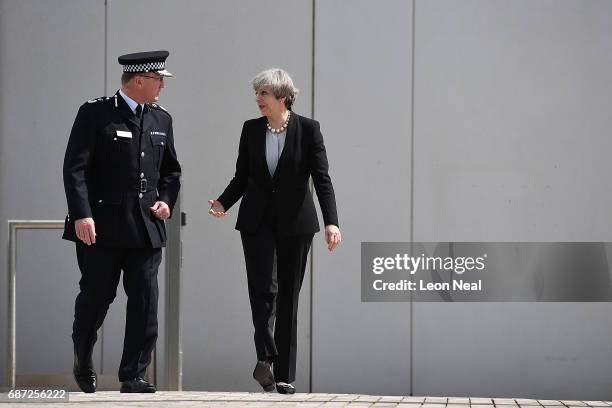 Britain's Prime Minister Theresa May talks with Chief Constable of Greater Manchester Police Ian Hopkins as they leave the Greater Manchester Police...