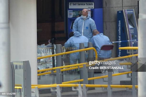 Forensics officers work at the scene at Manchester Victoria station in central Manchester, northwest England on May 23, 2017 following a deadly...