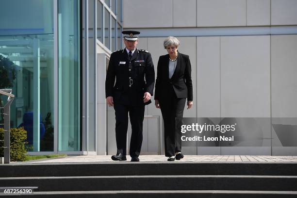 Britain's Prime Minister Theresa May talks with Chief Constable of Greater Manchester Police Ian Hopkins as they leave the Greater Manchester Police...