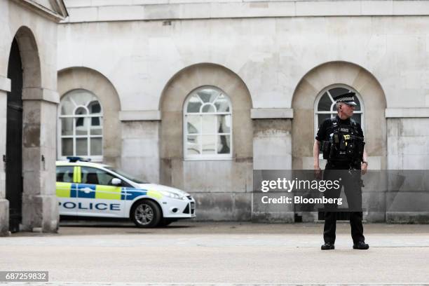 An armed police officer stands guard at Horse Guards Parade in London, U.K., on Tuesday, May 23, 2017. At least 22 people were killed in a suicide...