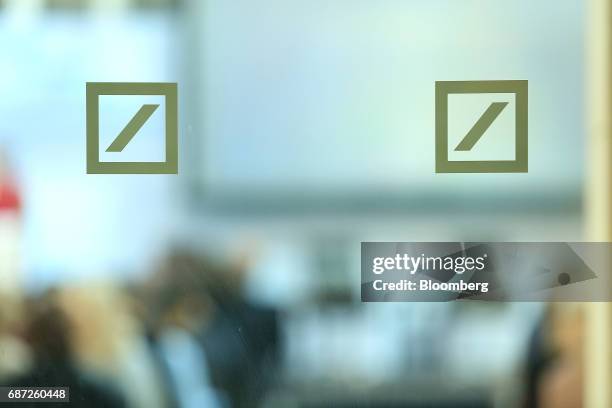 Deutsche Bank AG logos sit on a glass panel during the German Institute for Economic Research in Berlin women's finance summit, inside Deutsche...