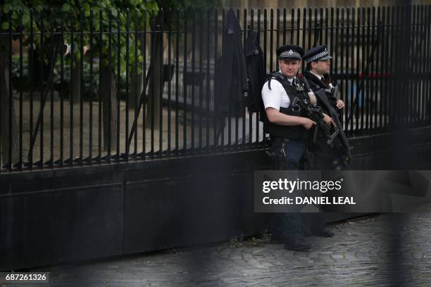 Armed British Police officers stand on duty outside of the Houses of Parliament in Westminster, central London on May 23 following the terror attack...