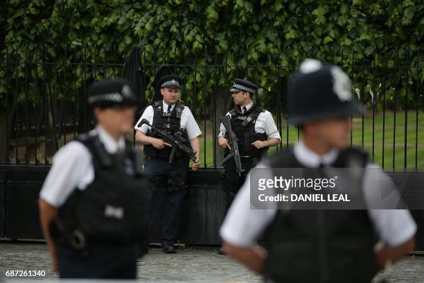 Armed British Police officers stand on duty outside of the Houses of Parliament in Westminster, central London on May 23 following the terror attack...