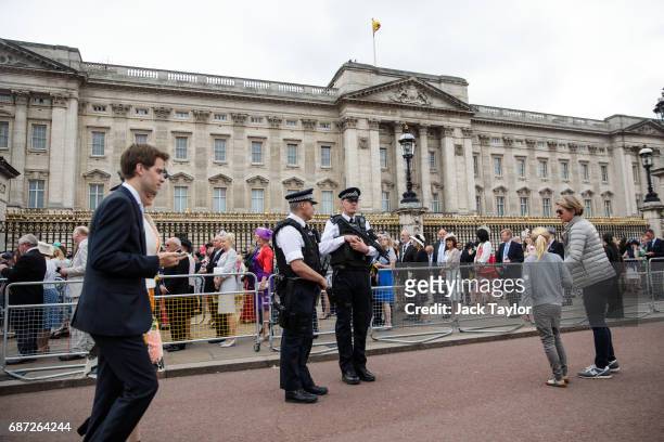 Armed police officers stand guard outside Buckingham Palace on May 23, 2017 in London, England. 22 people, including children have been killed and 59...