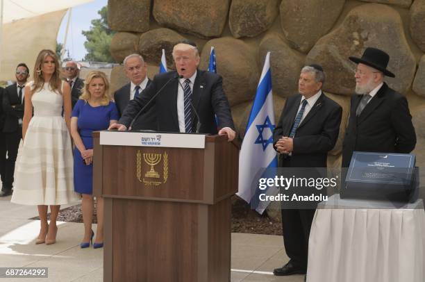 President Donald Trump makes a speech as his wife Melania Trump , Israeli Prime Minister Benjamin Netanyahu and his wife Sara Netanyahu stand behind...