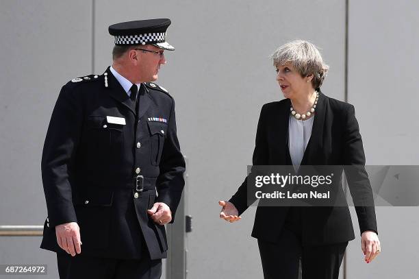 Britain's Prime Minister Theresa May talks with Chief Constable of Greater Manchester Police Ian Hopkins as they leave the Greater Manchester Police...