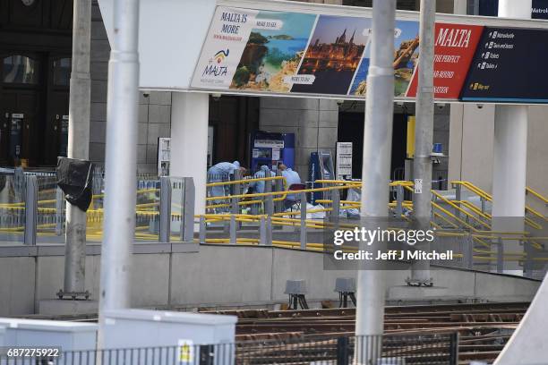 Forensics officers work at the scene at Manchester Arena on May 23, 2017 in Manchester, England. At least 22 people were killed in a suicide bombing...