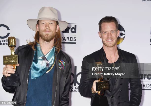 Recording artists Brian Kelley and Tyler Hubbard of the music group Florida Georgia Line pose in the press room at the 2017 Billboard Music Awards at...